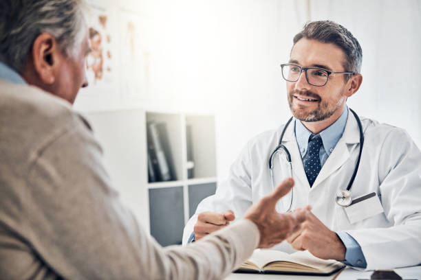 Shot of a friendly doctor consulting with a mature patient in his office